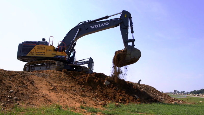 A Volvo excavator moving earth.